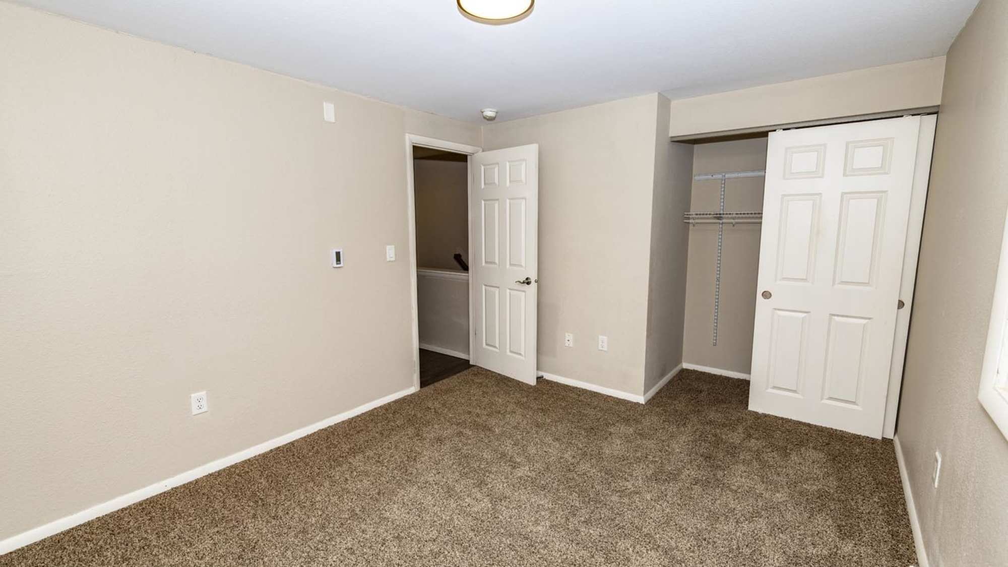 Bedroom with a closet at Taylor Crossing in Green Bay, Wisconsin