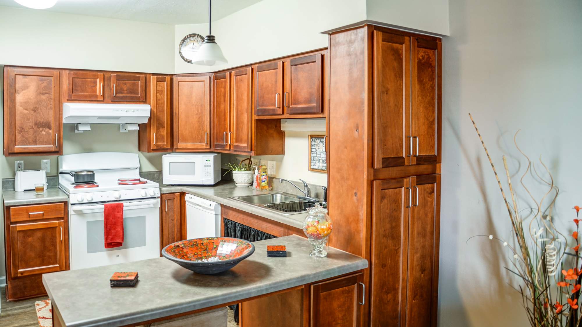 Kitchen with wooden cabinets and a breakfast counter at The Banks At Berkley in Norfolk, Virginia