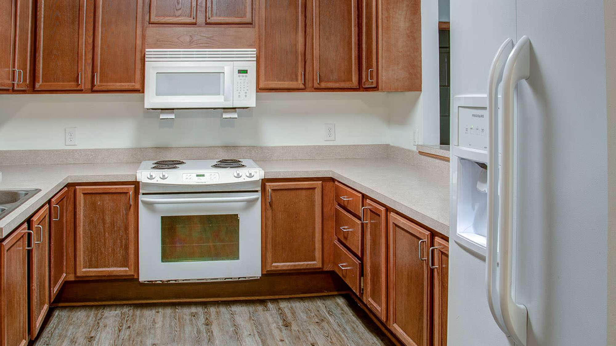 Kitchen with wooden cabinets and a microwave at City View Place in Richmond, Virginia
