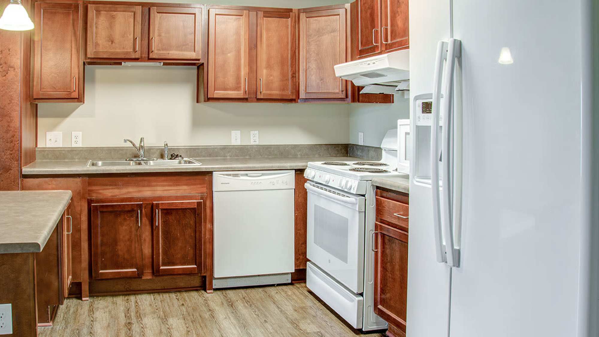 Kitchen with a refrigerator and a microwave at Brennan Pointe I in Newport News, Virginia