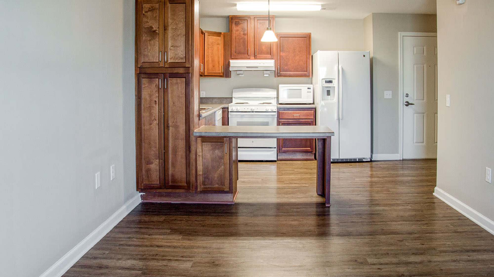Modern kitchen with wooden cabinets at Brennan Pointe I in Newport News, Virginia