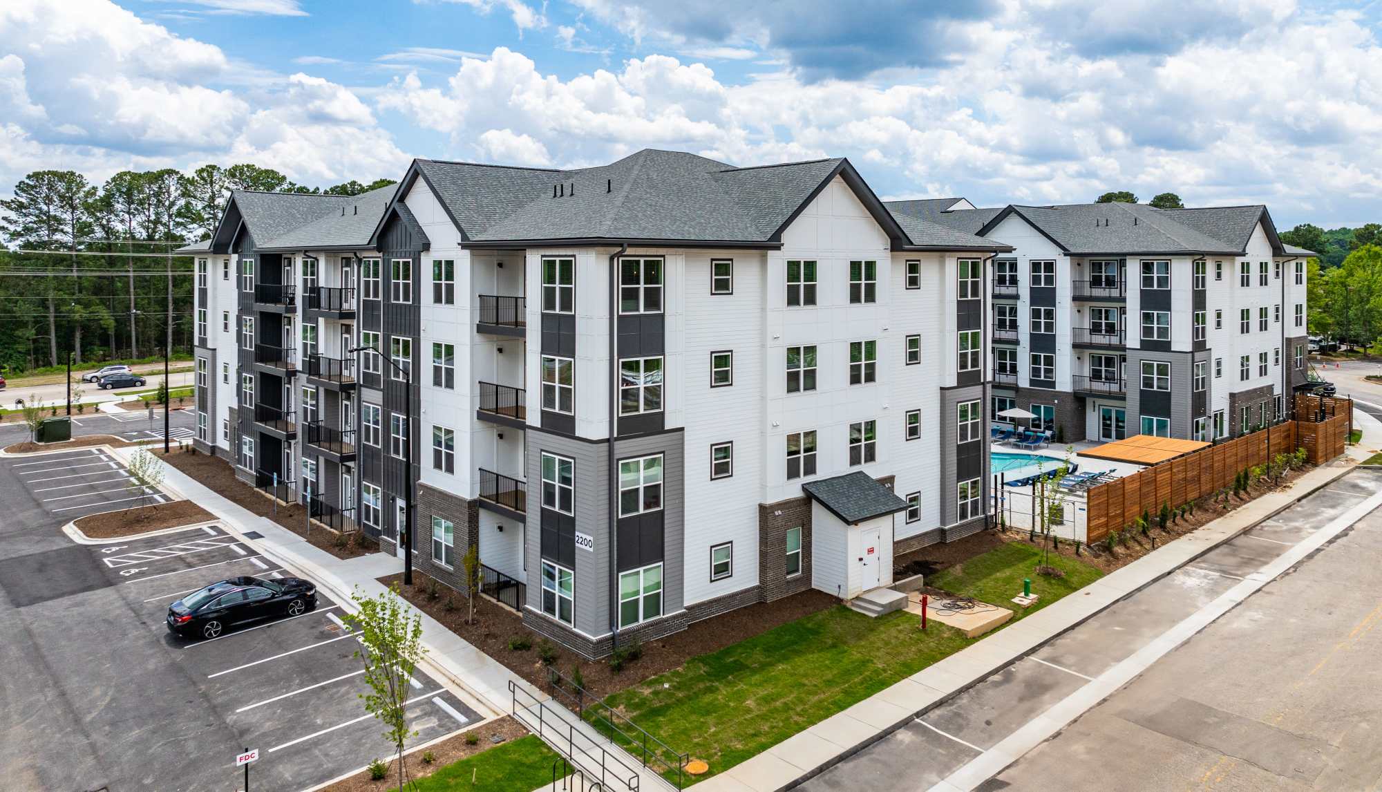 Exterior view of modern apartment community with landscaped grounds at Ironwood on North Salem in Apex, North Carolina