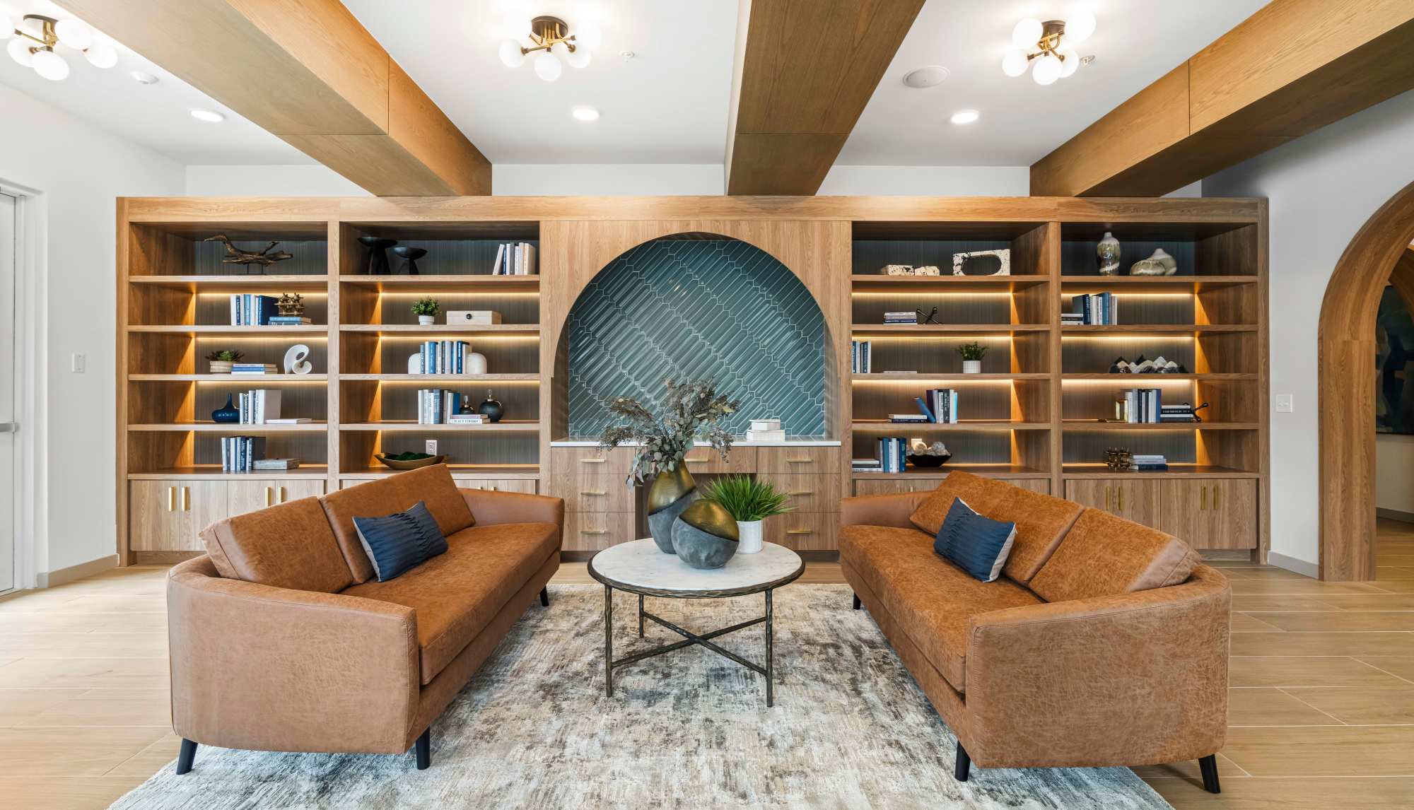 Community library and lounge with built-in shelving and seating at Ironwood on North Salem in Apex, North Carolina