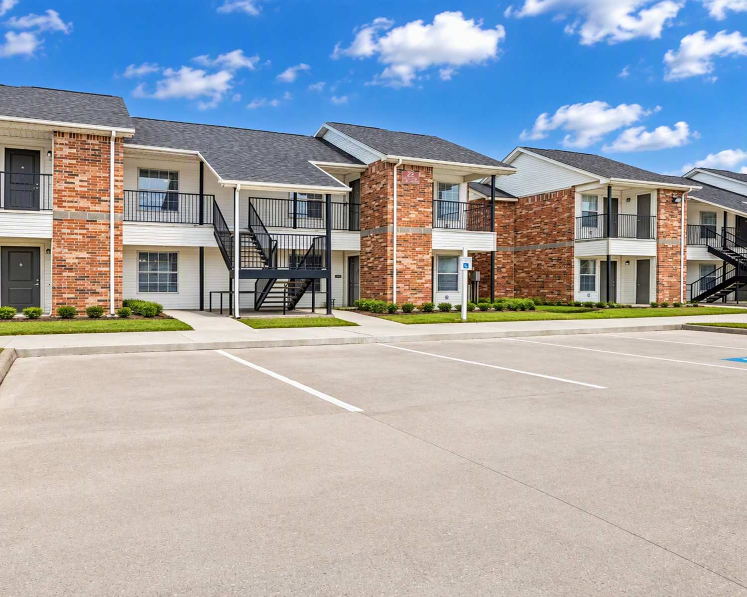 Brick exterior building with balconies and stairs at Meadowbrook Plaza in Houston, Texas