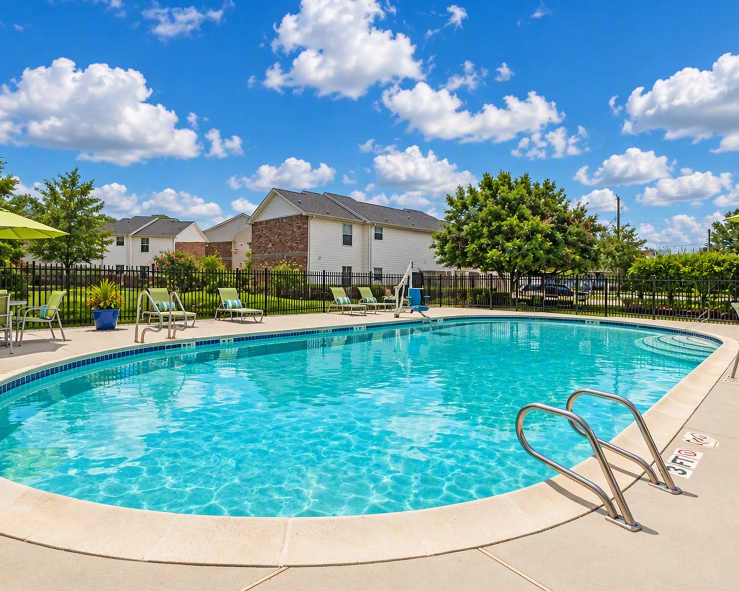 Swimming pool with lounge chairs and umbrellas at Meadowbrook Plaza in Houston, Texas