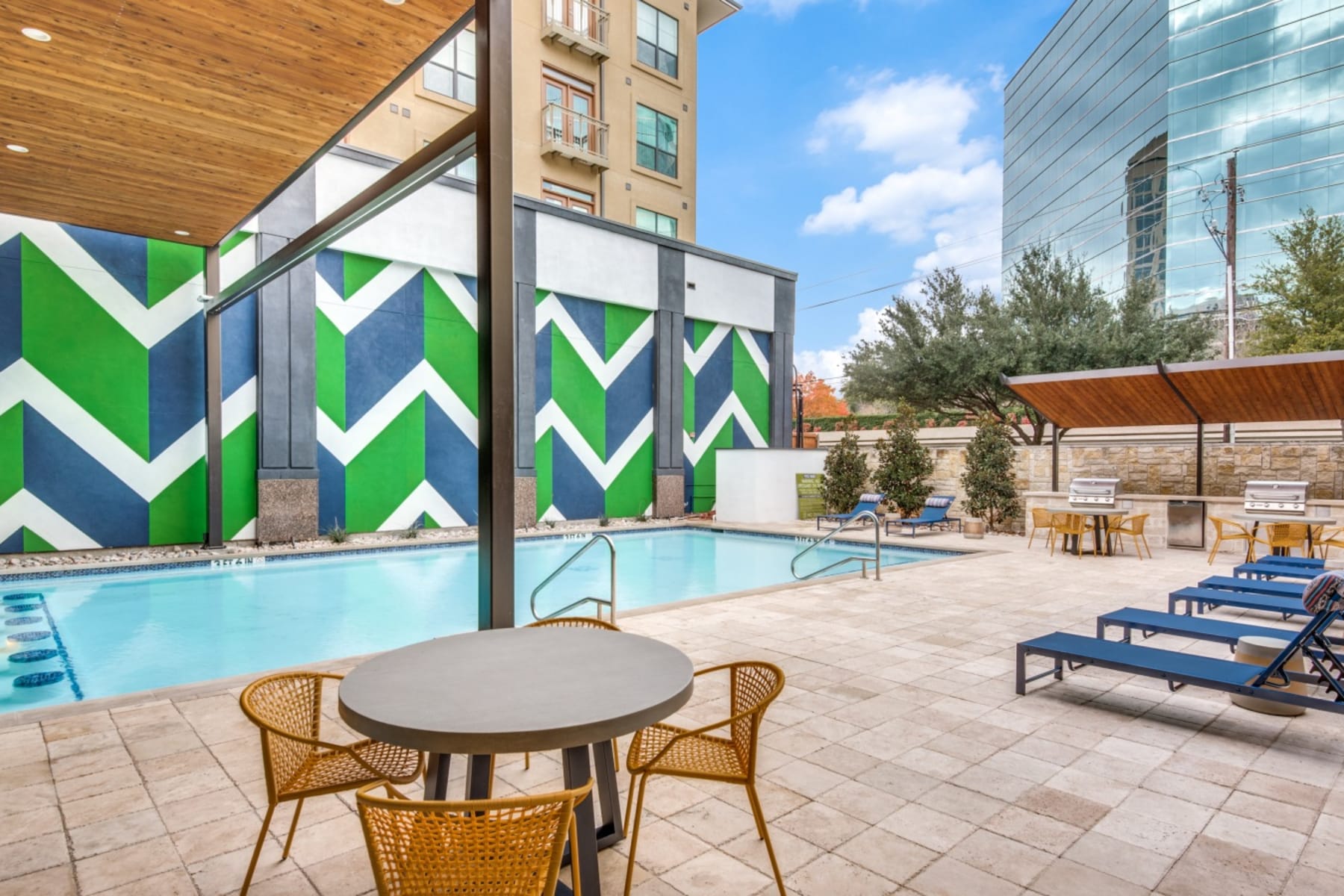 Poolside table at Cleo Luxury Apartments in Dallas, Texas
