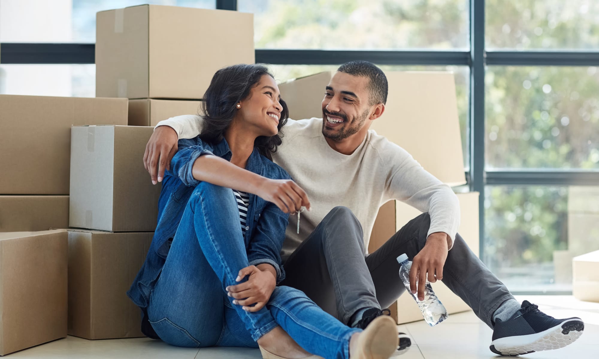 A couple sitting in front of moving boxes near Castro Valley Hayward Storage in Castro Valley, California