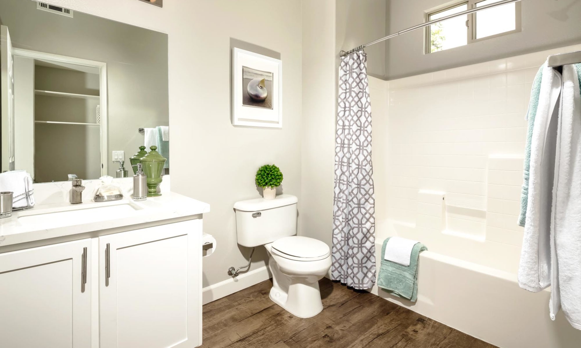 Bathroom with hardwood flooring and a tiled shower in a model home at Mission Hills in Camarillo, California