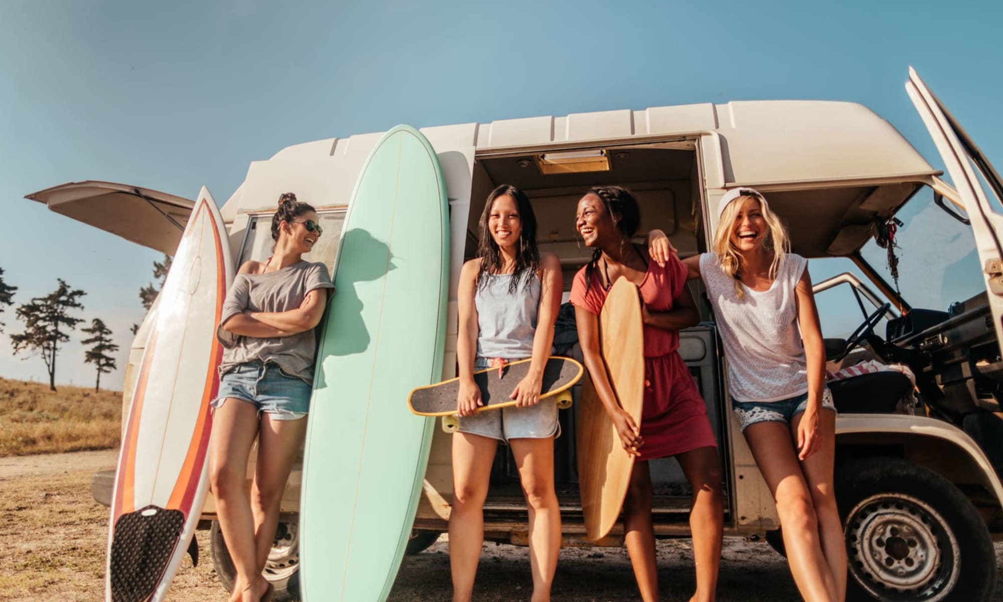A group of happy young people with surfboards near West Park Village in Los Angeles, California