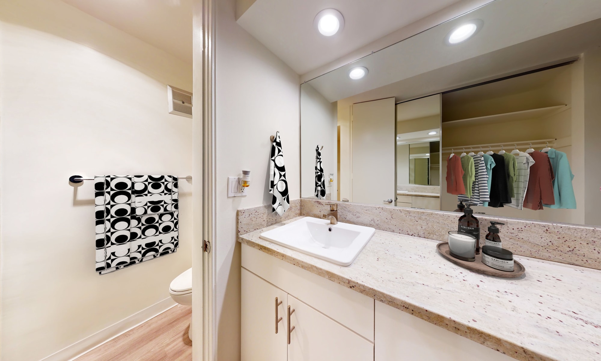 Expansive quartz countertop and an oversized vanity mirror in the of a studio apartment at Rancho Los Feliz in Los Angeles, California