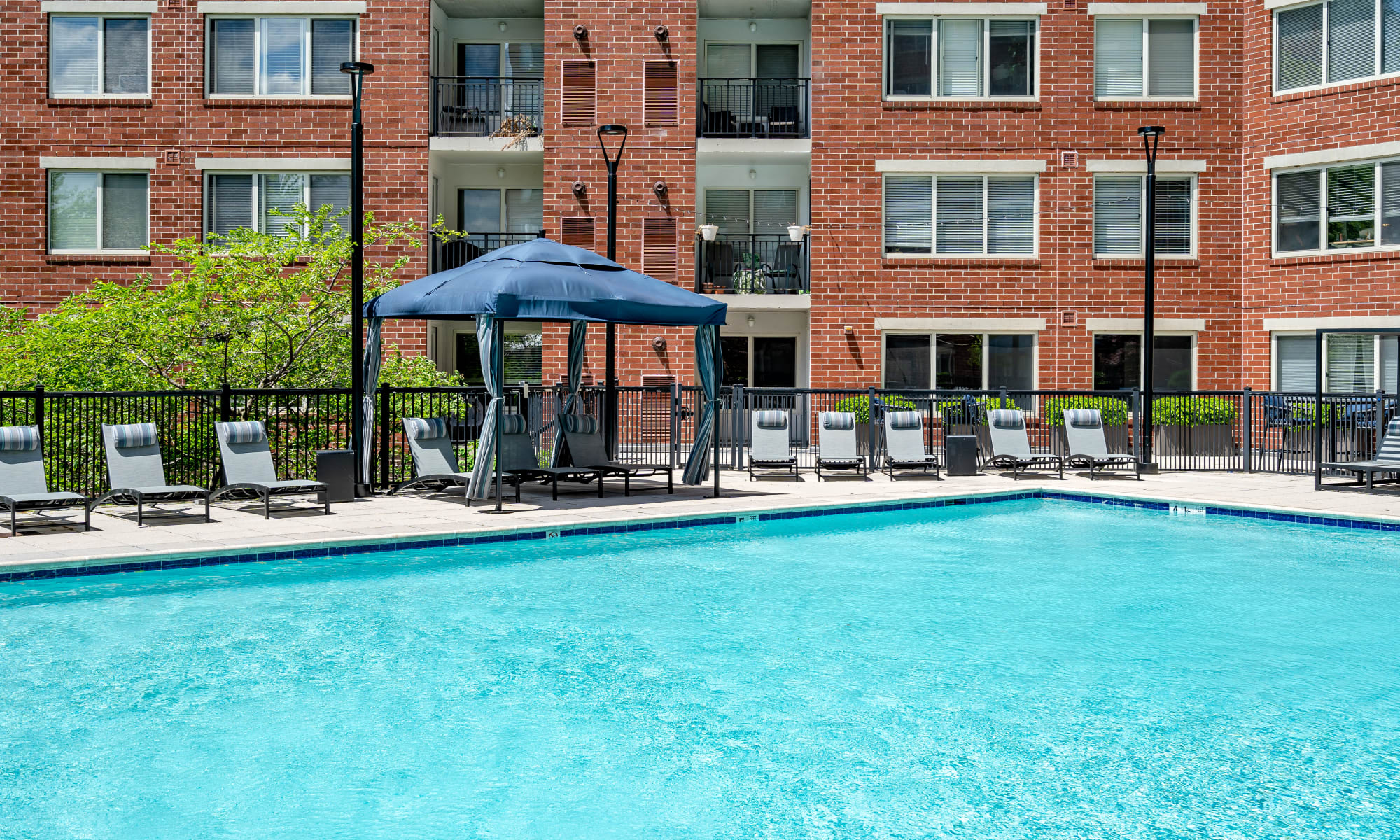 Resident outdoor pool and lounge chairs Stamford, Connecticut, at Sofi at 50 Forest