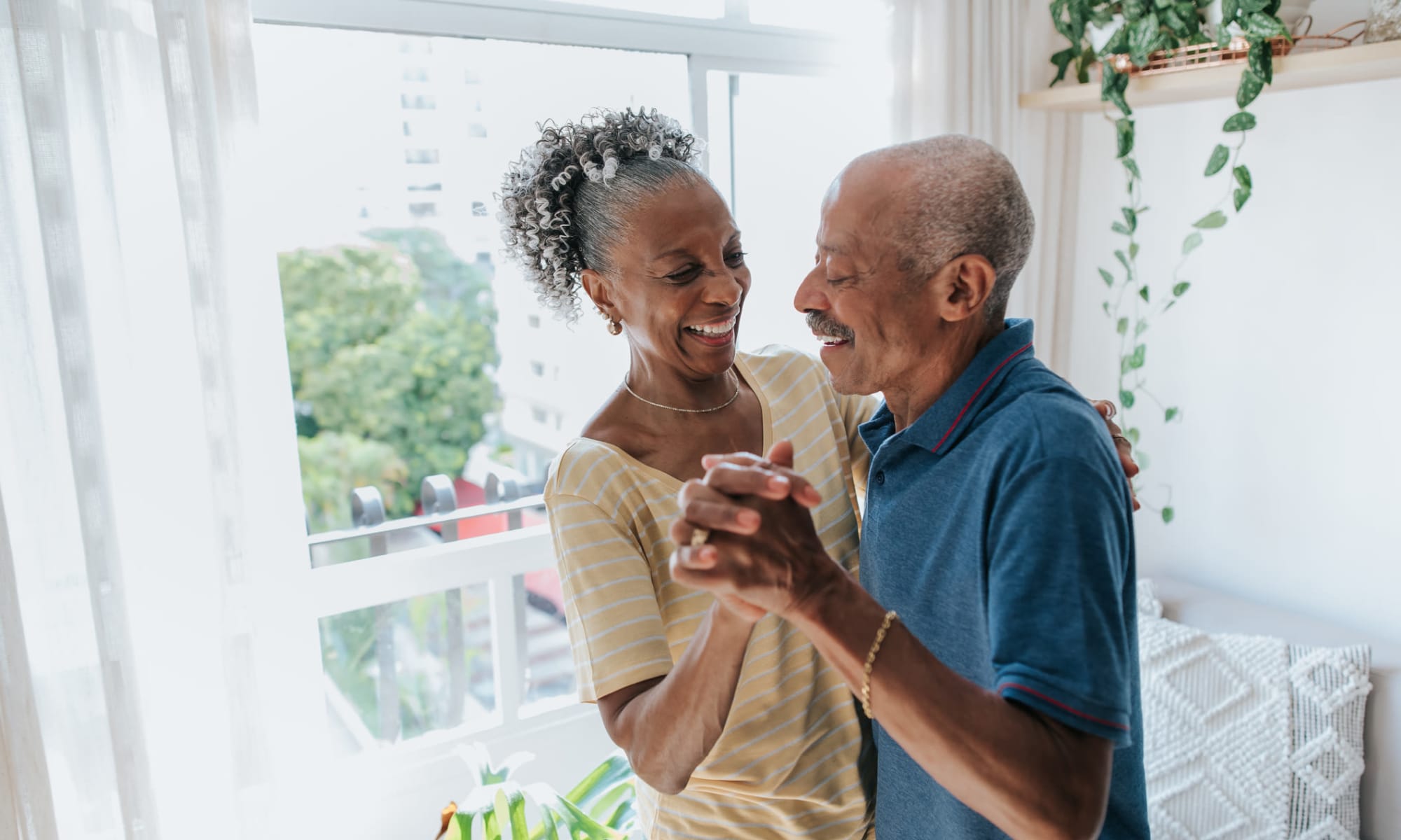 Senior residents dancing together in their home at Greater New Hope Tower Apartments in Baltimore, Maryland