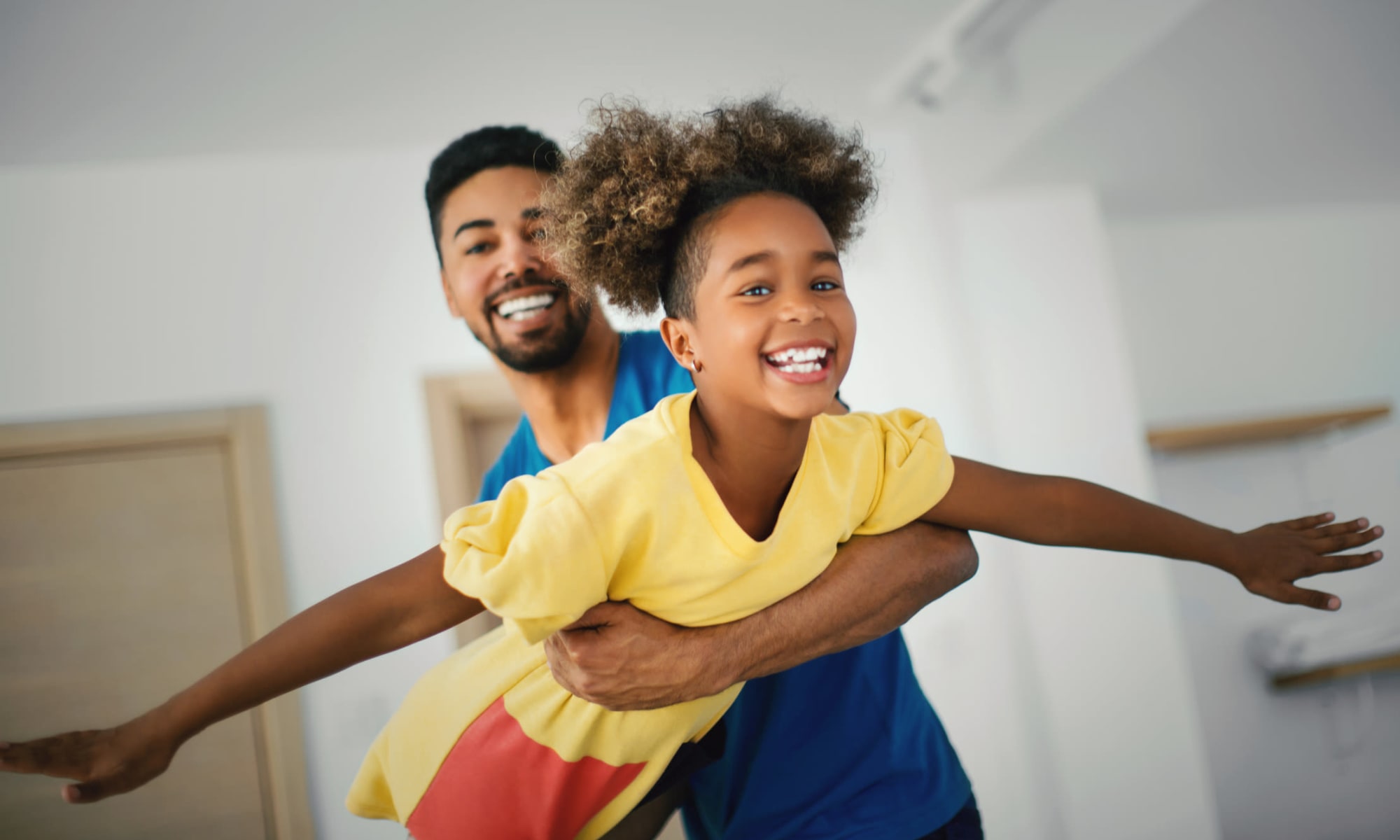 Father and child playing at New Shiloh Village Family Apartments in Baltimore, Maryland