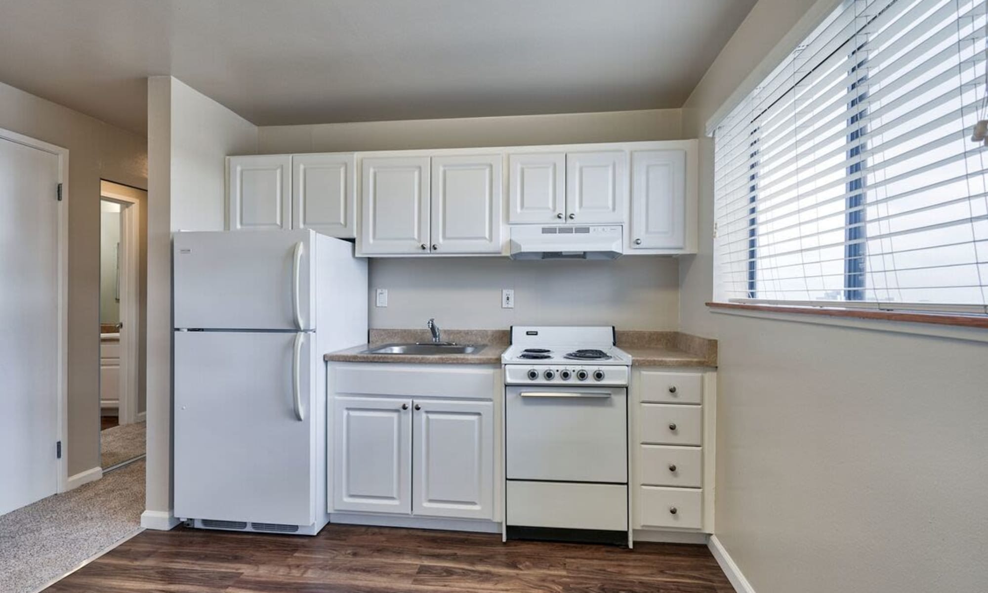 white appliances in the kitchen at Woodmont Apartments in Belmont, California