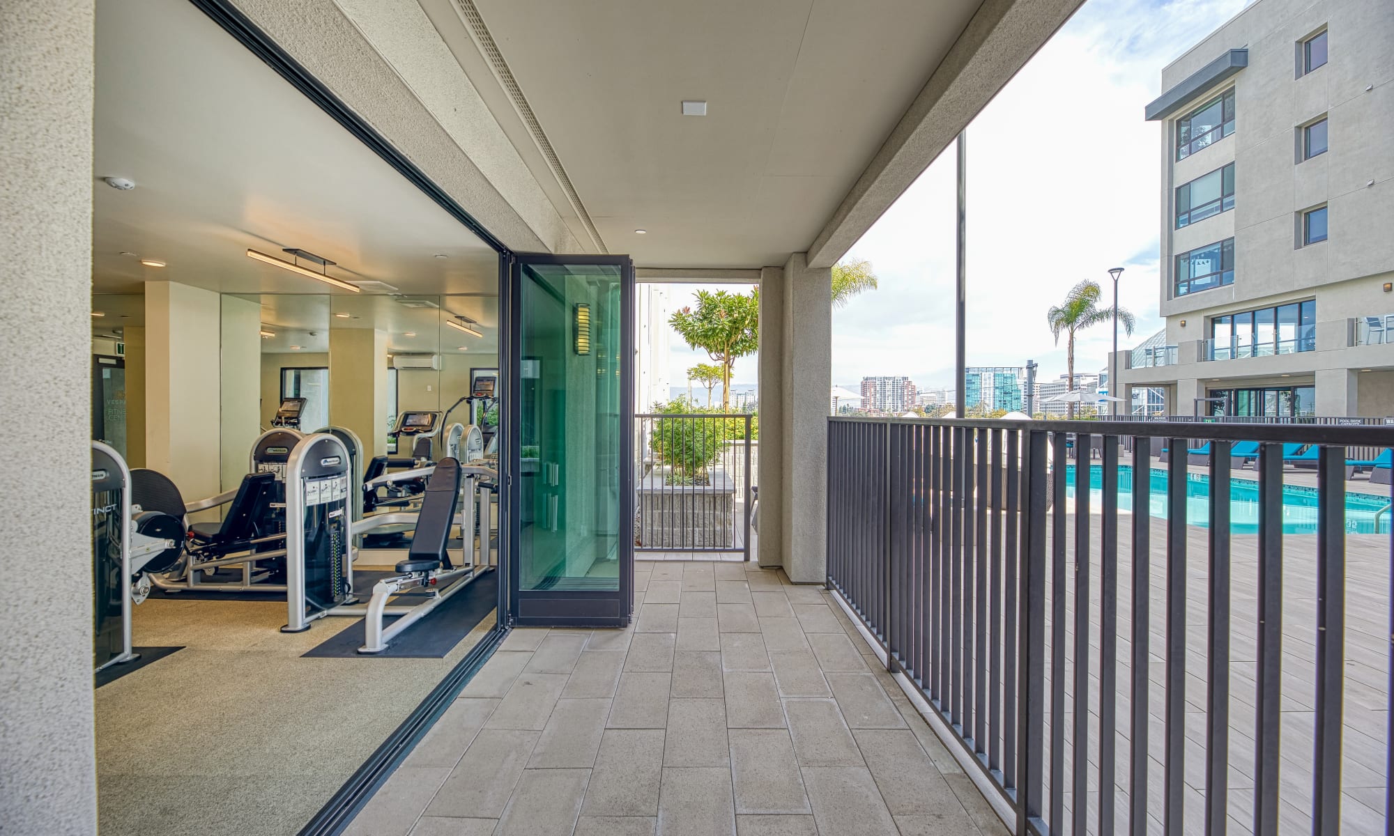 Vespaio in San Jose, California features a fitness center with large sliding doors that open on to outdoor patio space