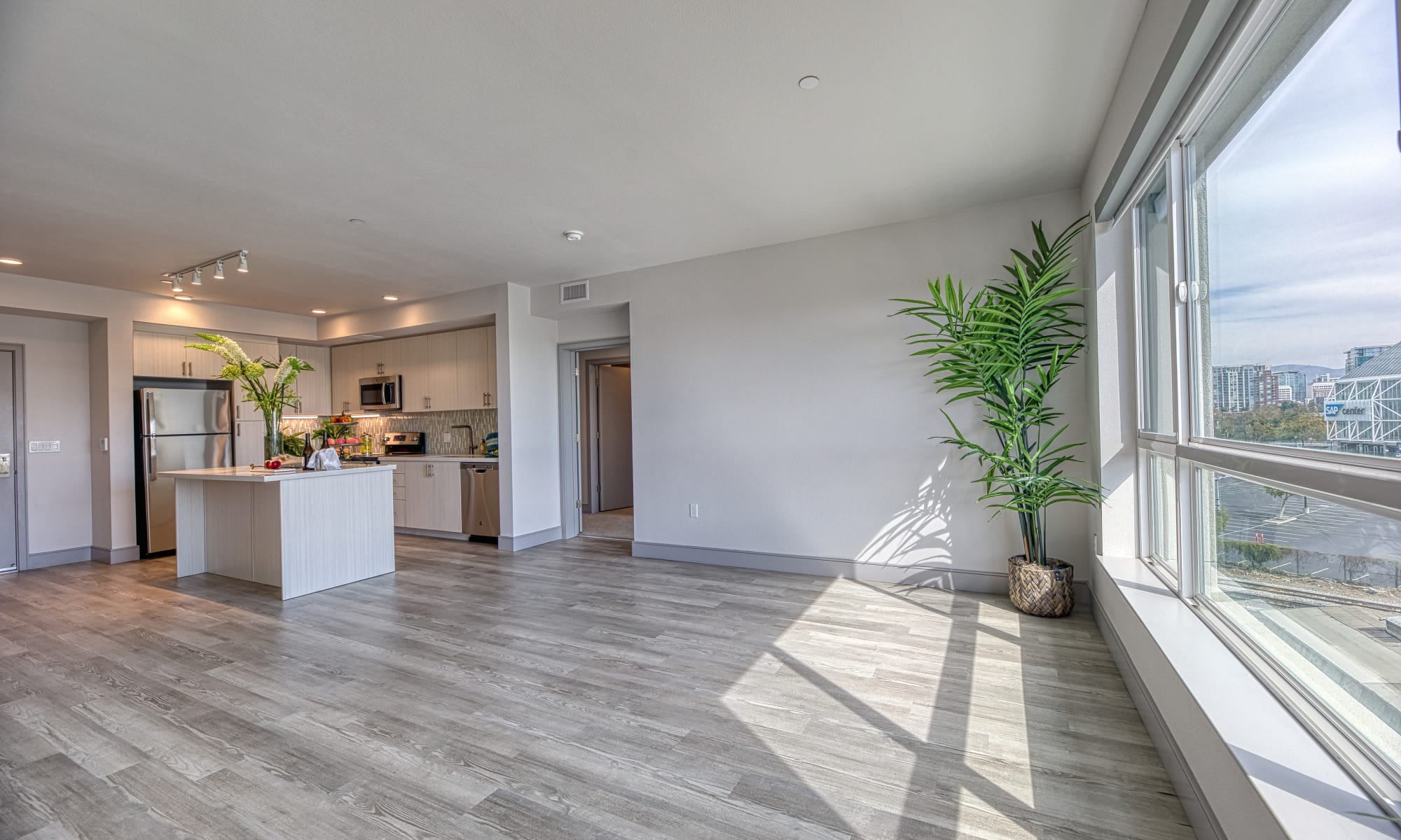 Spacious living room and kitchen featuring breakfast bar at Vespaio in San Jose, California