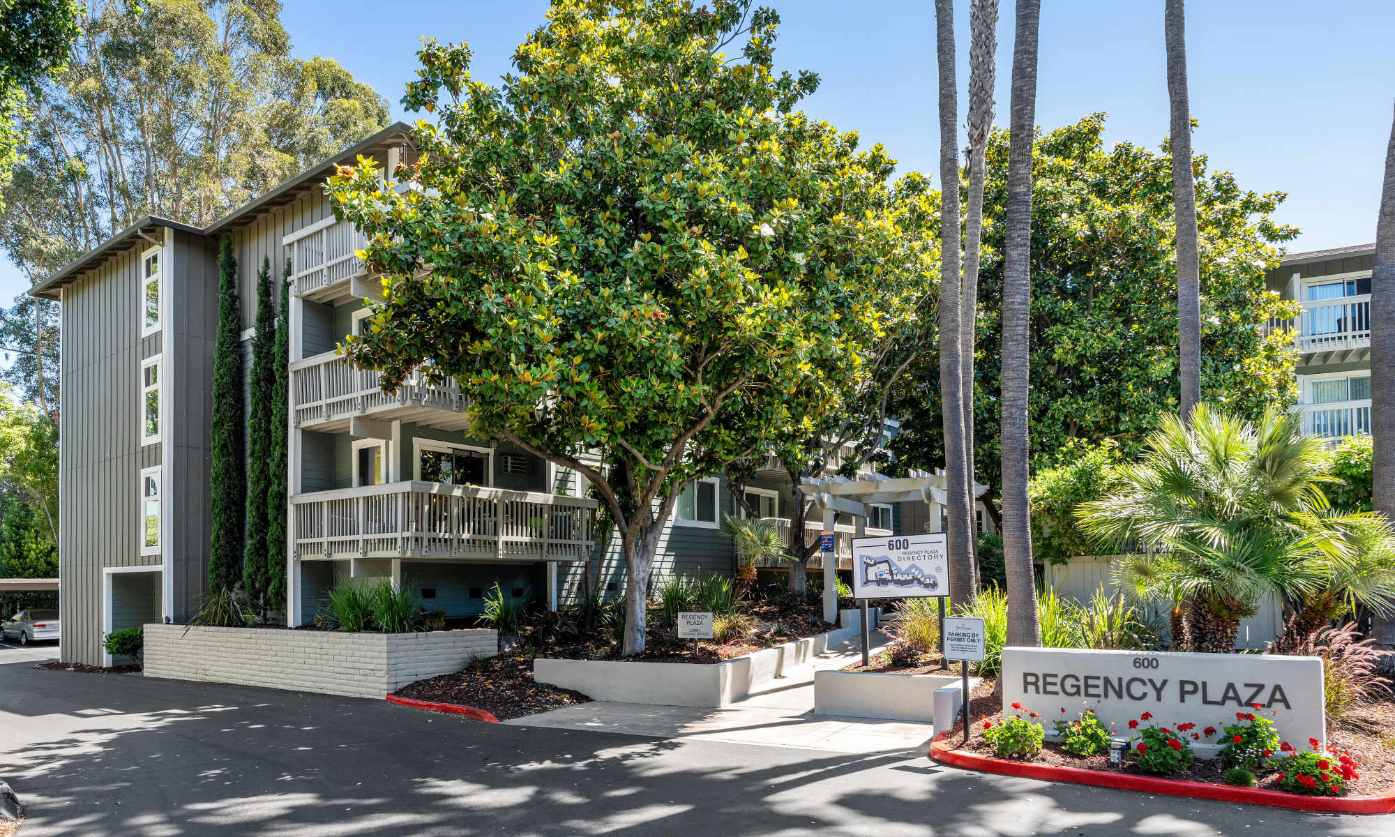 Apartment exterior with greenery at Regency Plaza Apartment Homes in Martinez, California