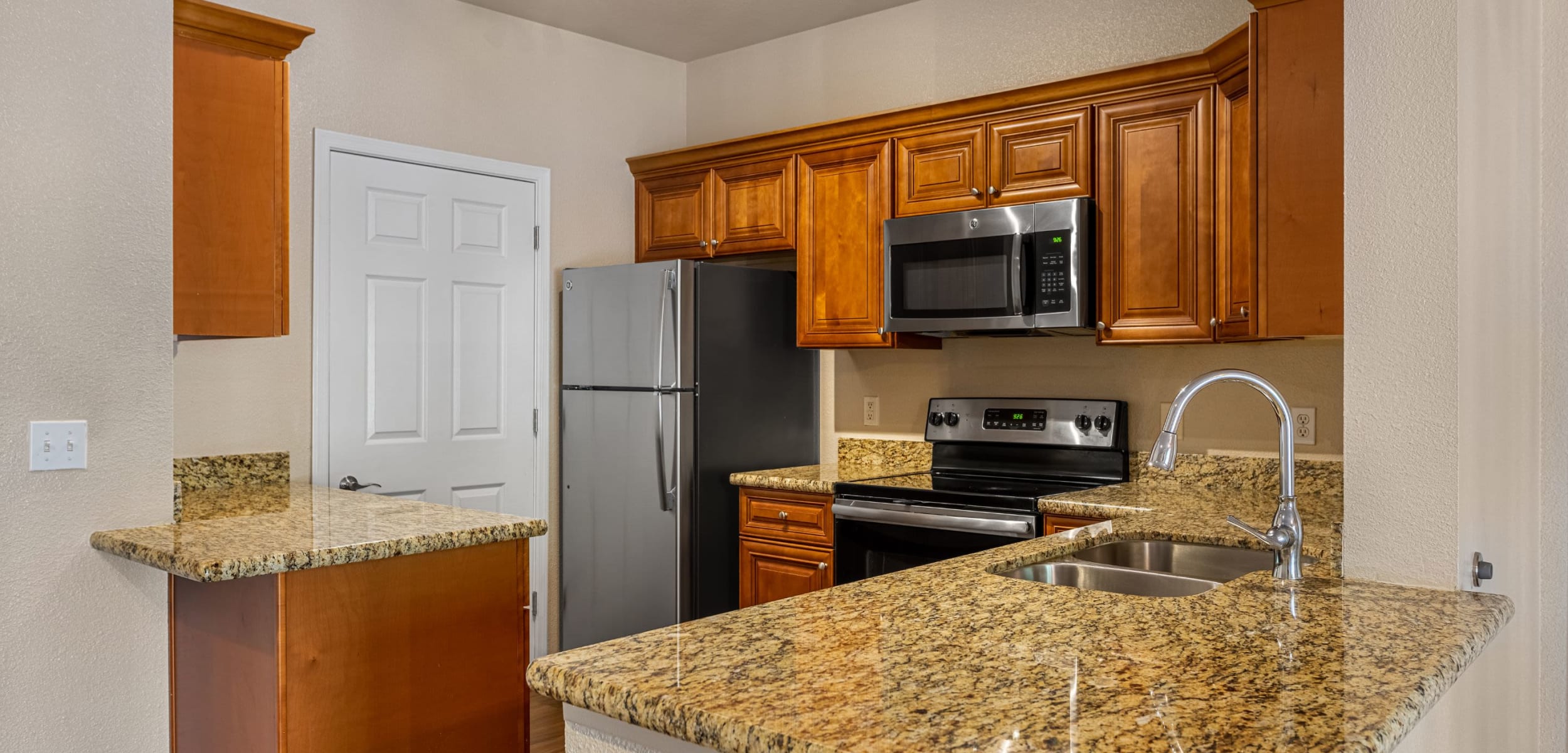 Modern kitchen with granite style counters at Azure Creek in Cave Creek, Arizona