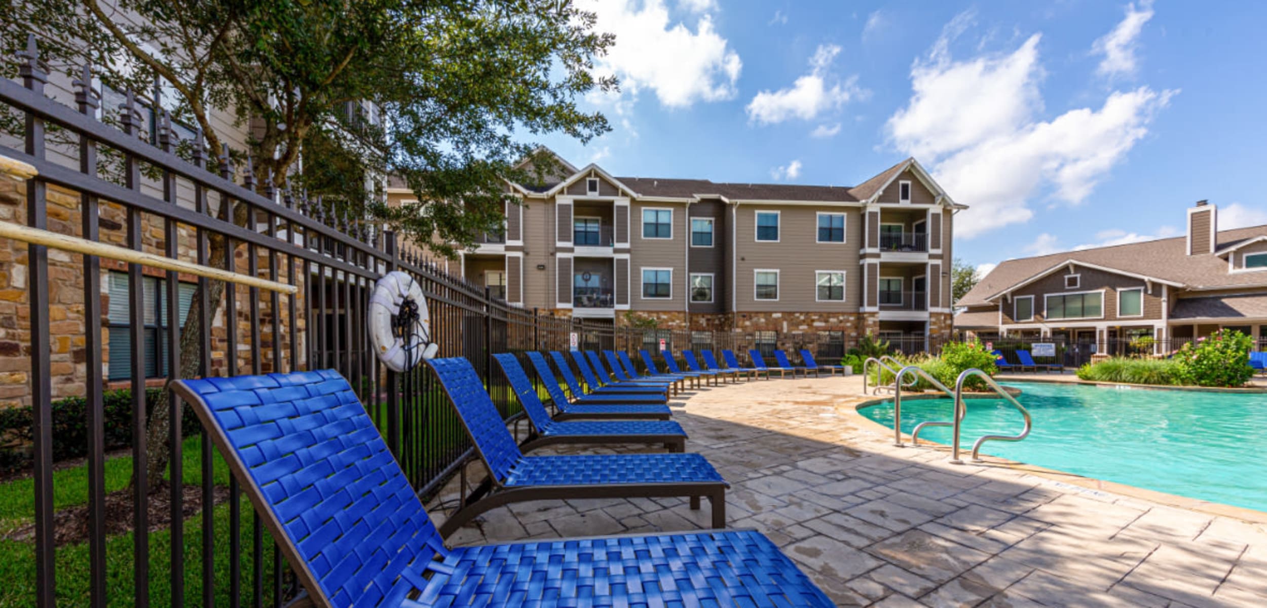 Pool deck and lounge area at Marquis at Katy in Katy Texas,