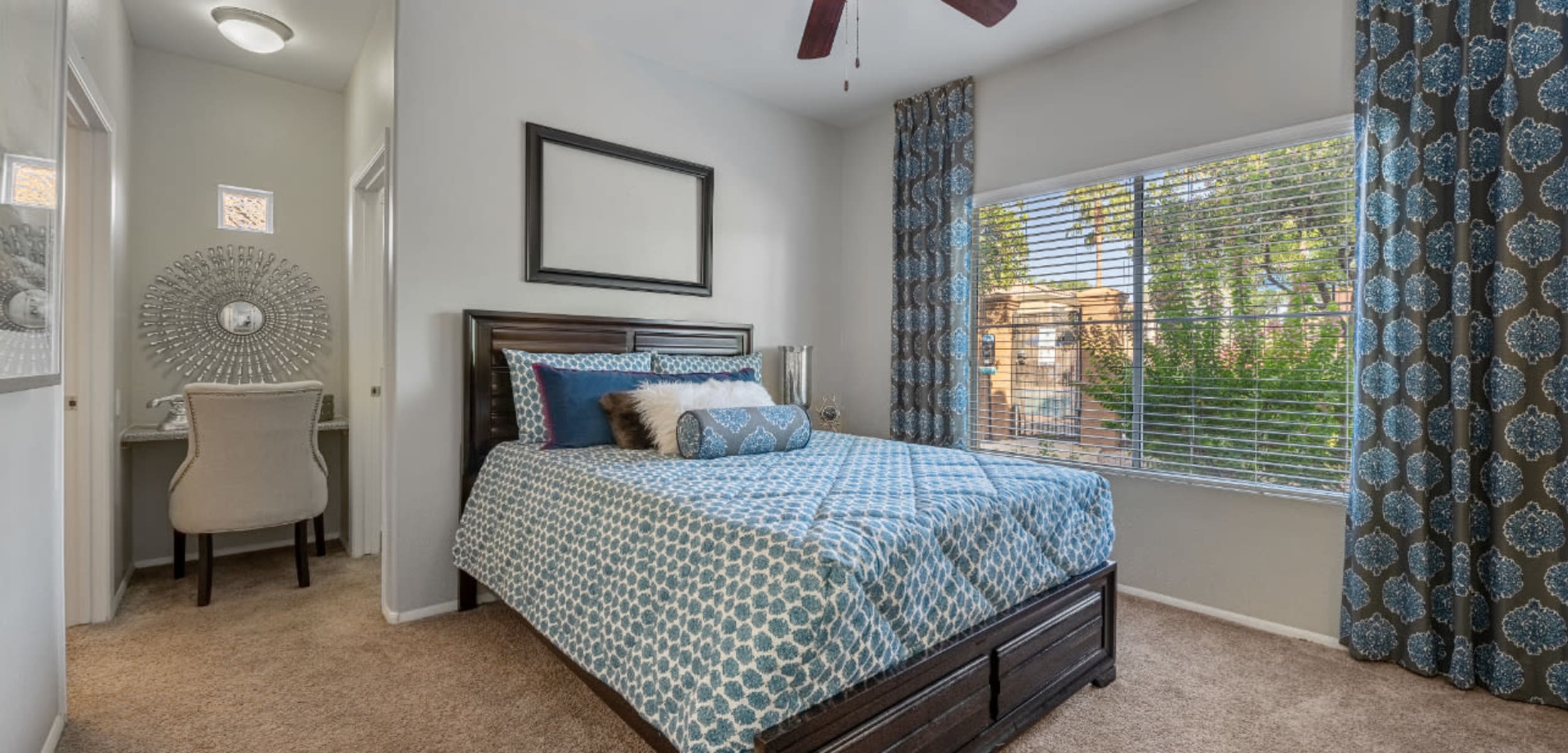 Bedroom with a large window and seating area at Alante at the Islands in Chandler, Arizona