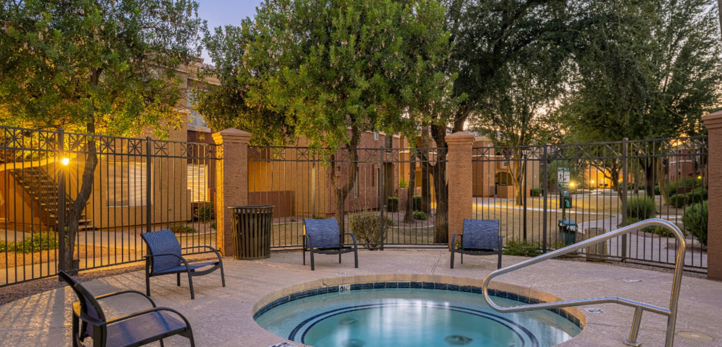 Enclosed hot tub area with cushioned chairs at Alante at the Islands in Chandler, Arizona