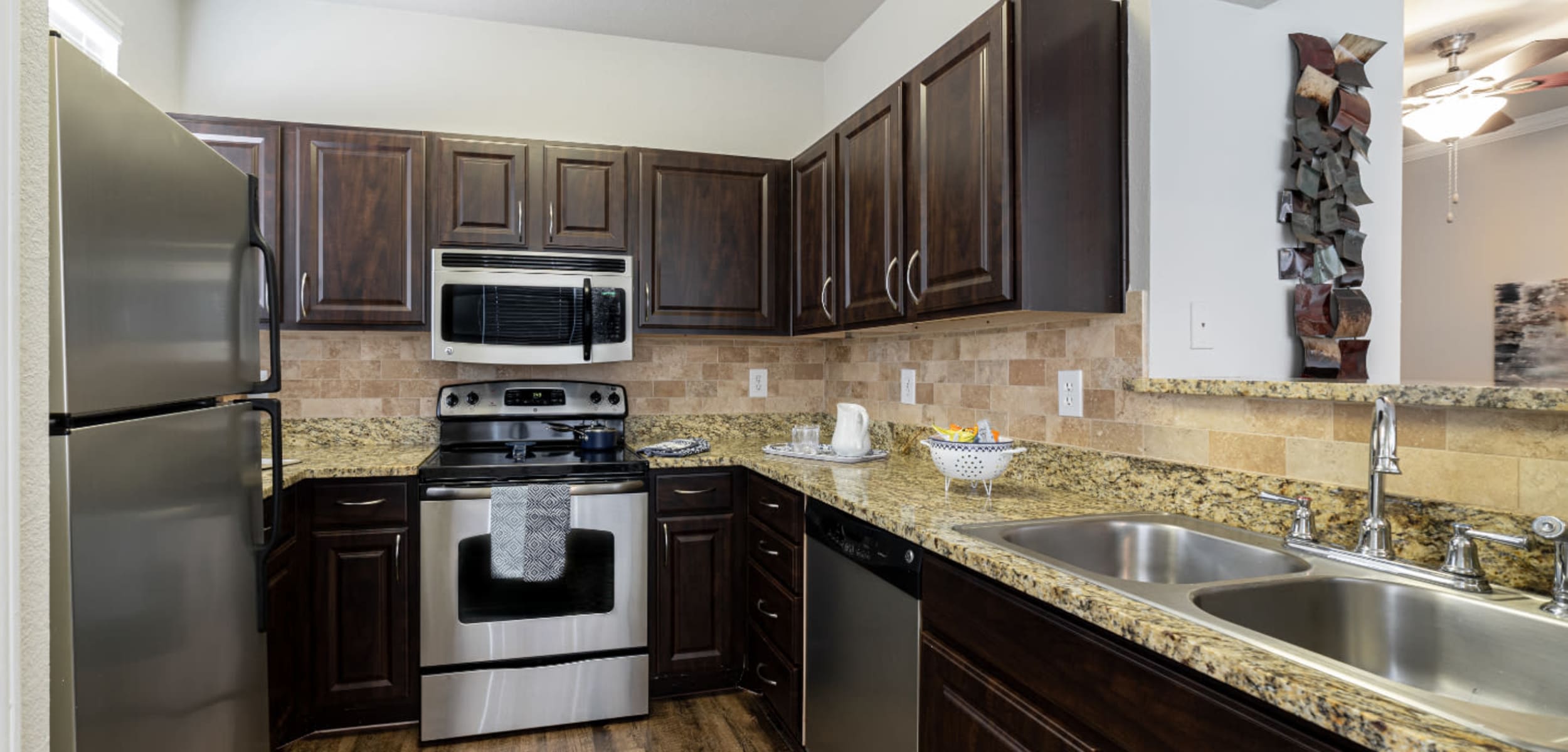 Modern style kitchen with granite counters at Marquis at Bellaire Ranch in Fort Worth, Texas