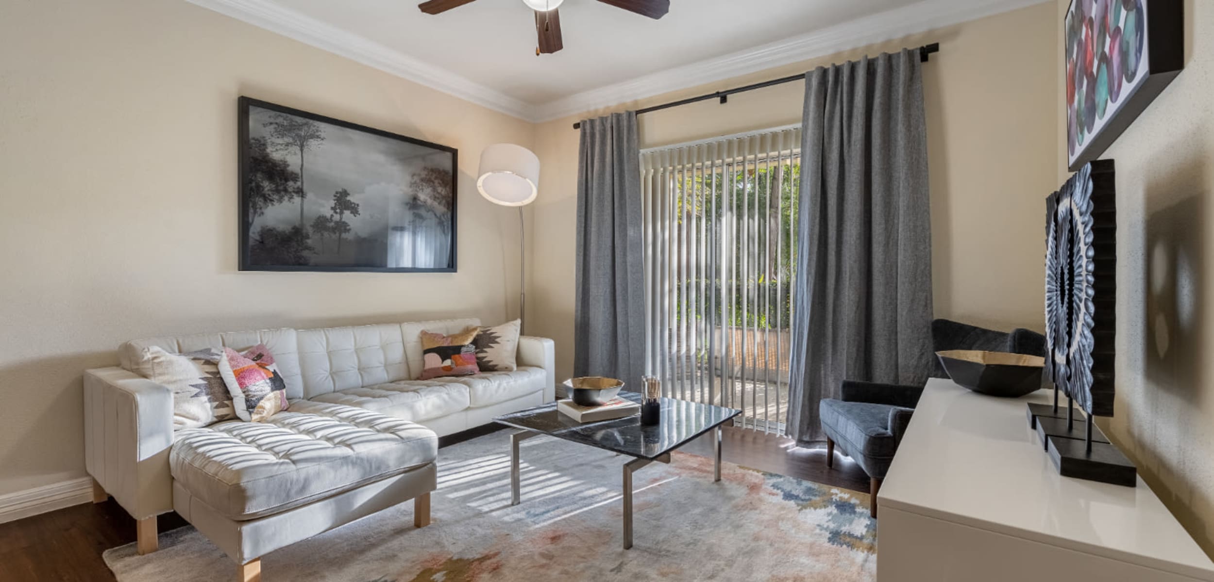 Modern and sleek living room with large rug on wood floor at Marquis at Kingwood in Kingwood, Texas