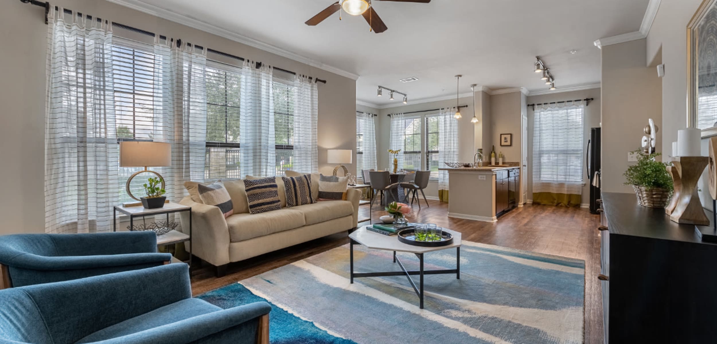 Spacious and comfortable living area overlooking kitchen and dining area at Marquis at Sugar Land in Sugar Land, Texas