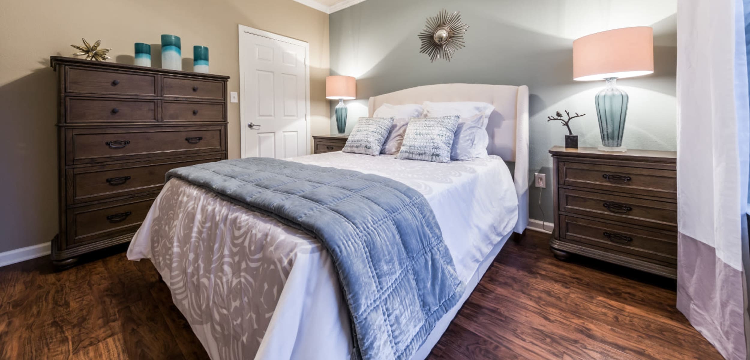 Large bedroom with wood flooring and ceiling fan at Marquis at The Cascades in Tyler, Texas