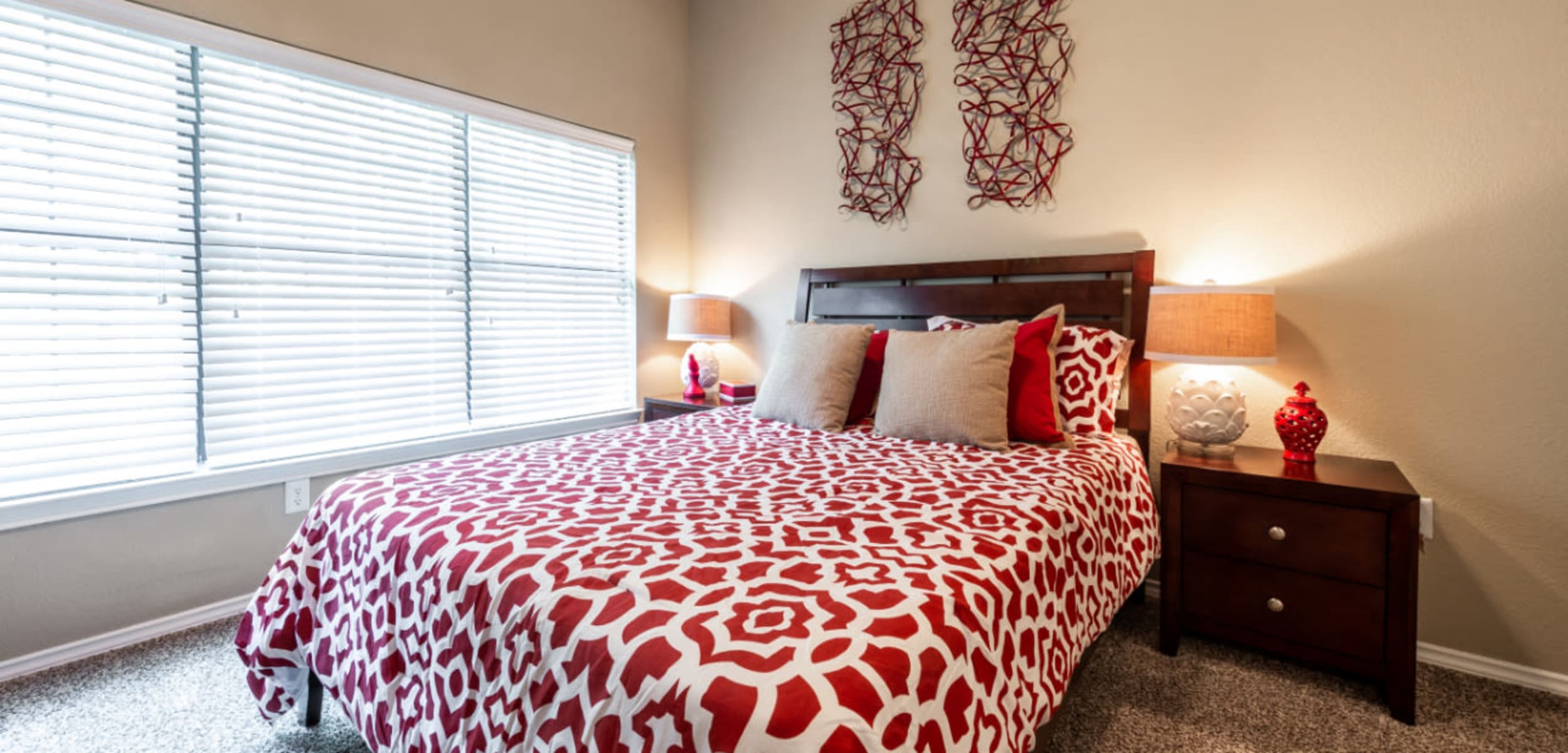 Bright and carpeted bedroom with multiple large windows at Marquis at Waterview in Richardson, Texas
