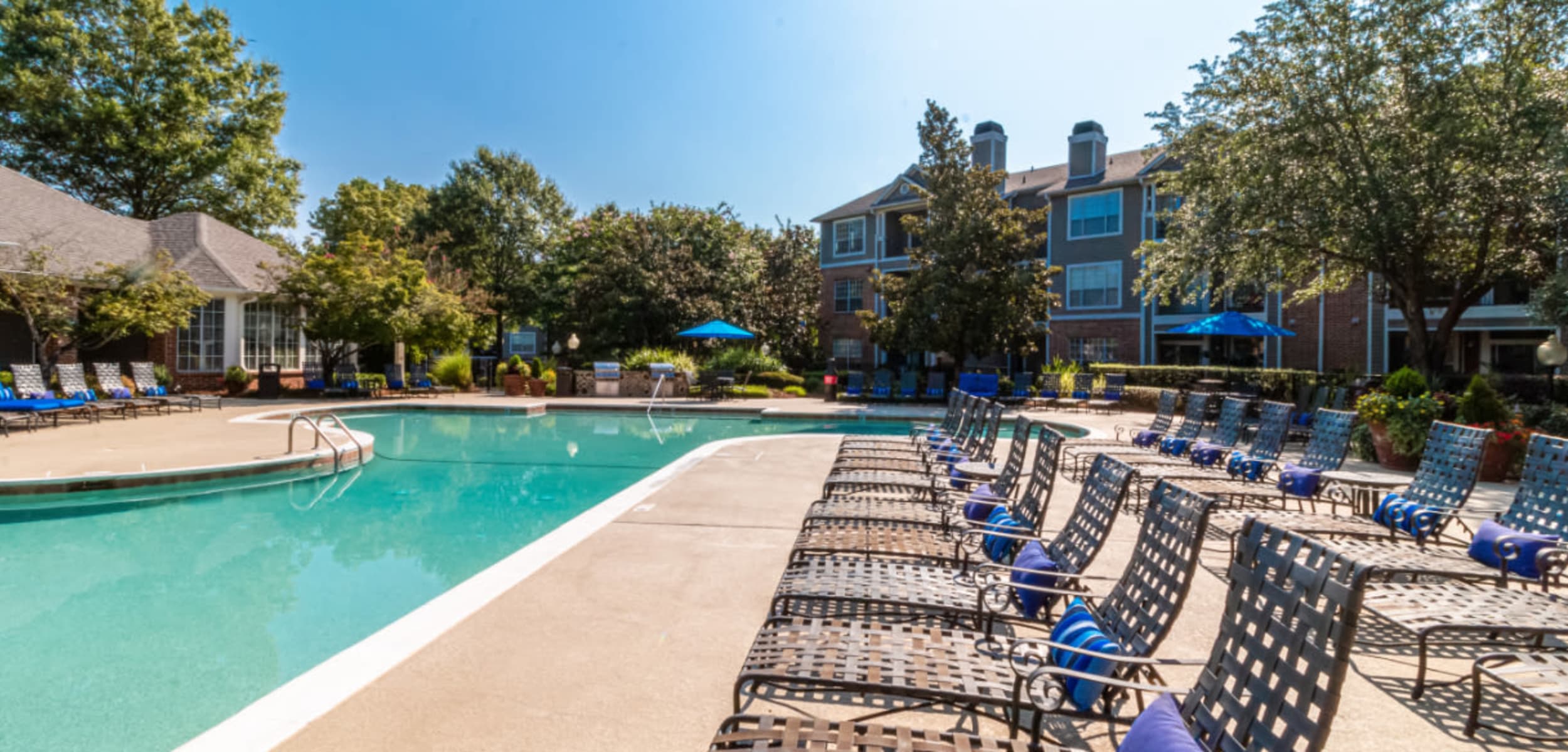 Lounge chairs lined up next to pool at Marquis of Carmel Valley in Charlotte, North Carolina