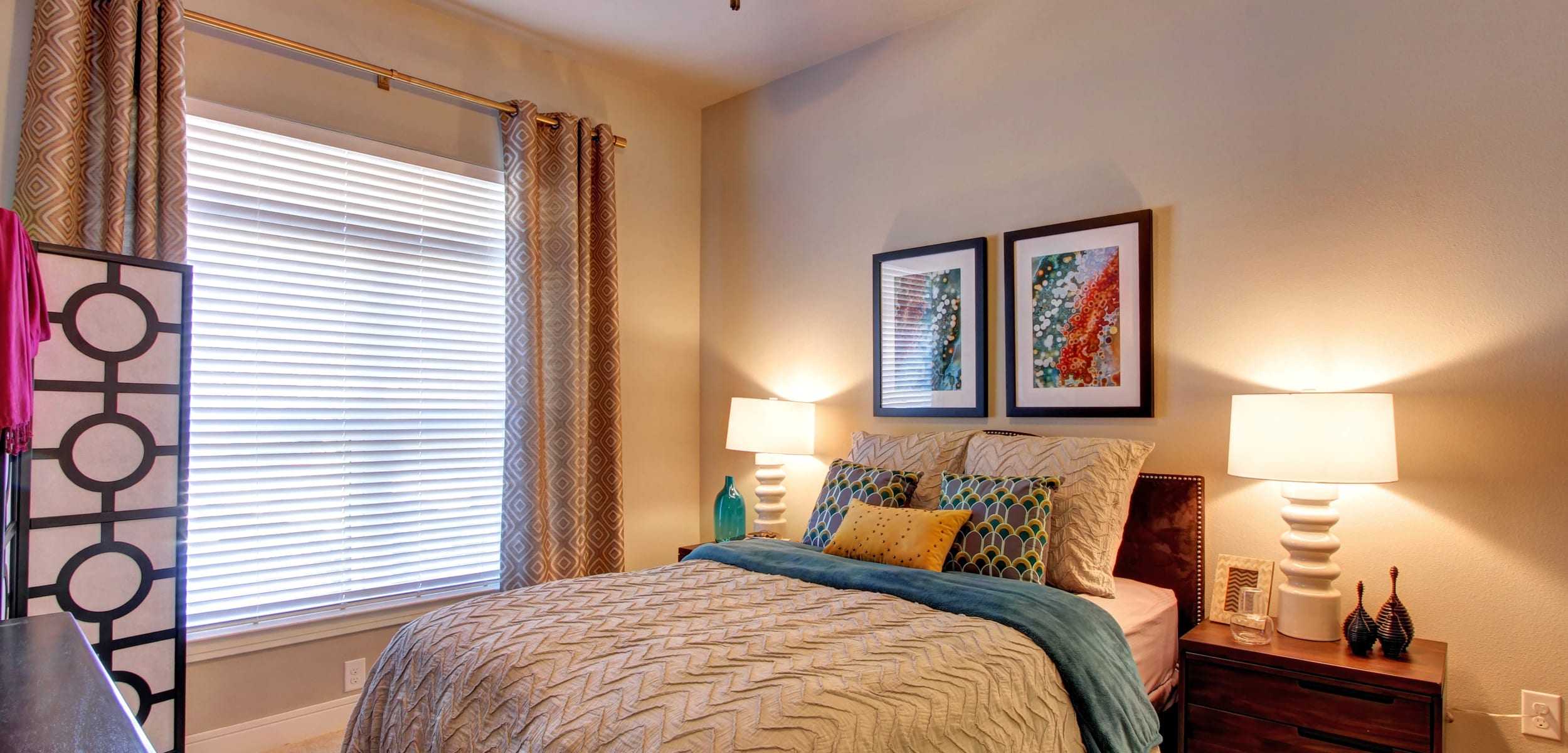 Carpeted bedroom with large window at Marquis at Barton Trails in Austin, Texas