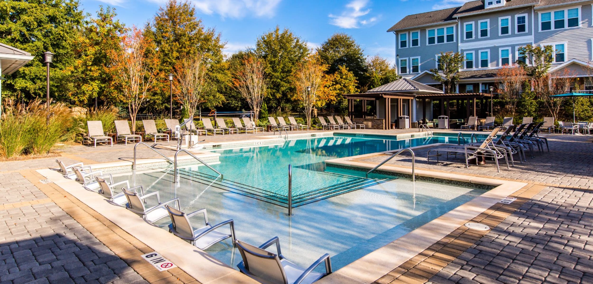 Pool with lounge seating at Marquis at Morrison Plantation in Mooresville, North Carolina