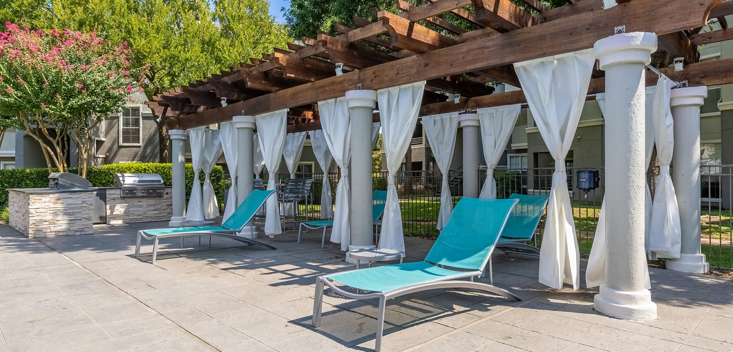 Lounge chairs, and gazebo area at Marquis at Stonegate in Fort Worth, Texas
