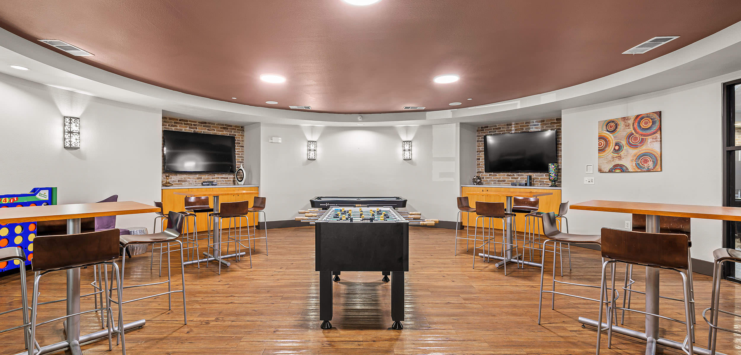 Recreation room with tables at Regents West at 26th in Austin, Texas