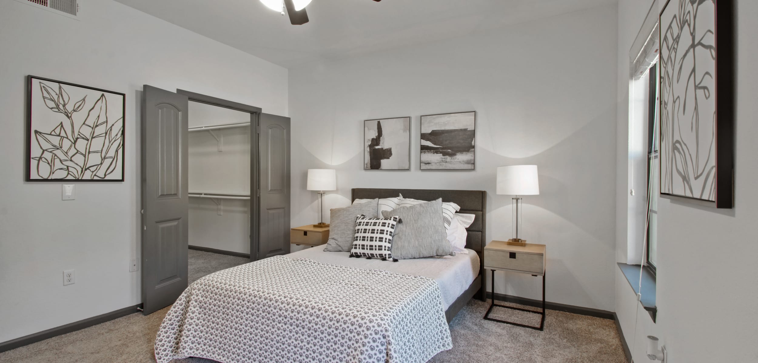 Model bedroom with two lamps and nightstands at Marquis on Evans in San Antonio, Texas
