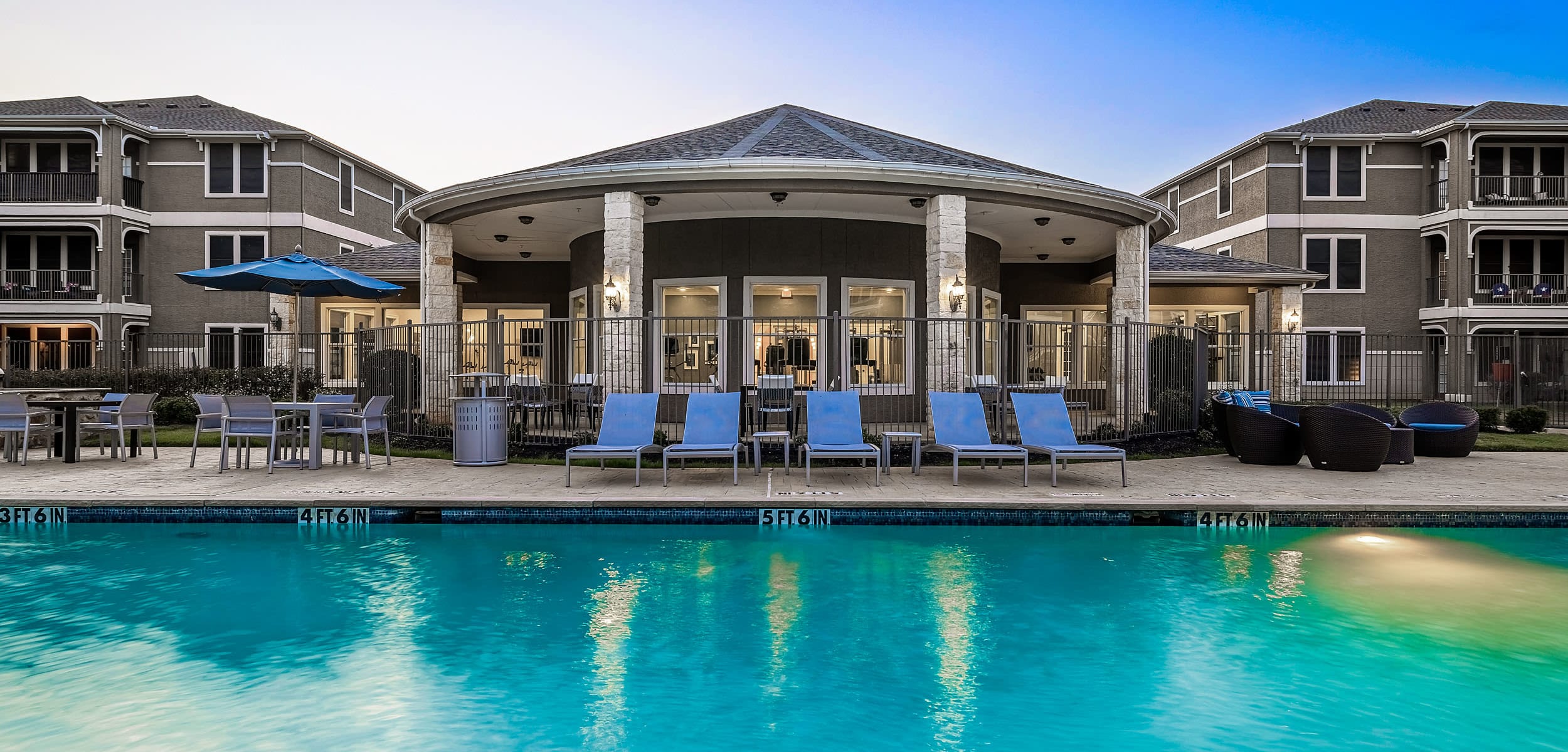 Sparkling pool facing clubhouse at sunset at Marquis at The Cascades in Tyler Texas,