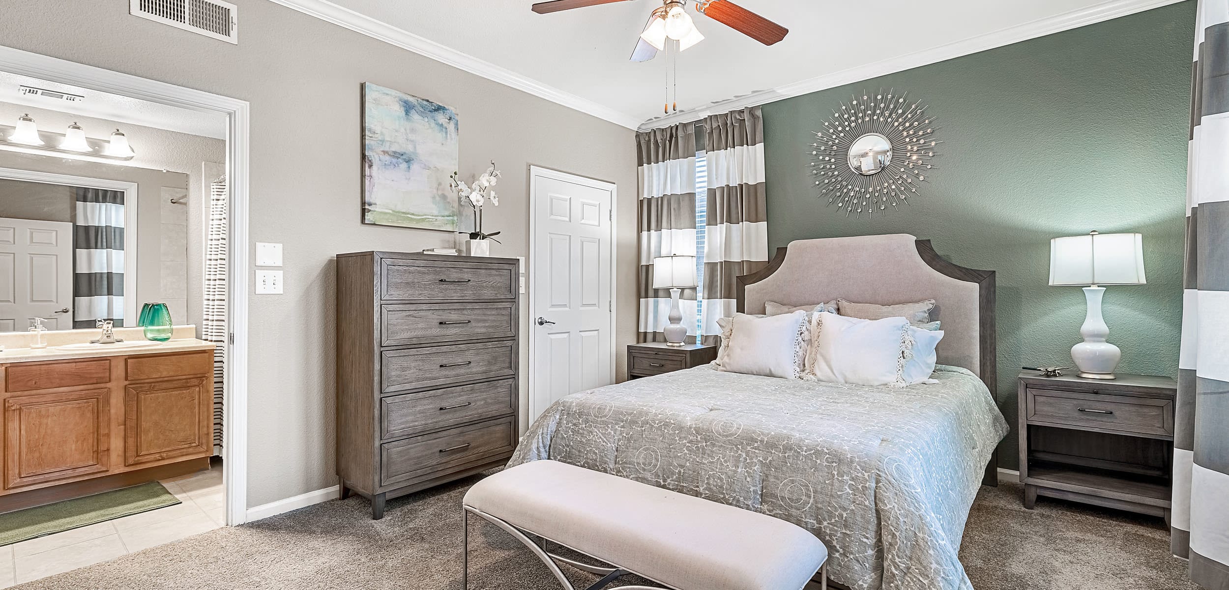 Large bedroom with carpet flooring and ceiling fan at Marquis at The Cascades in Tyler, Texas