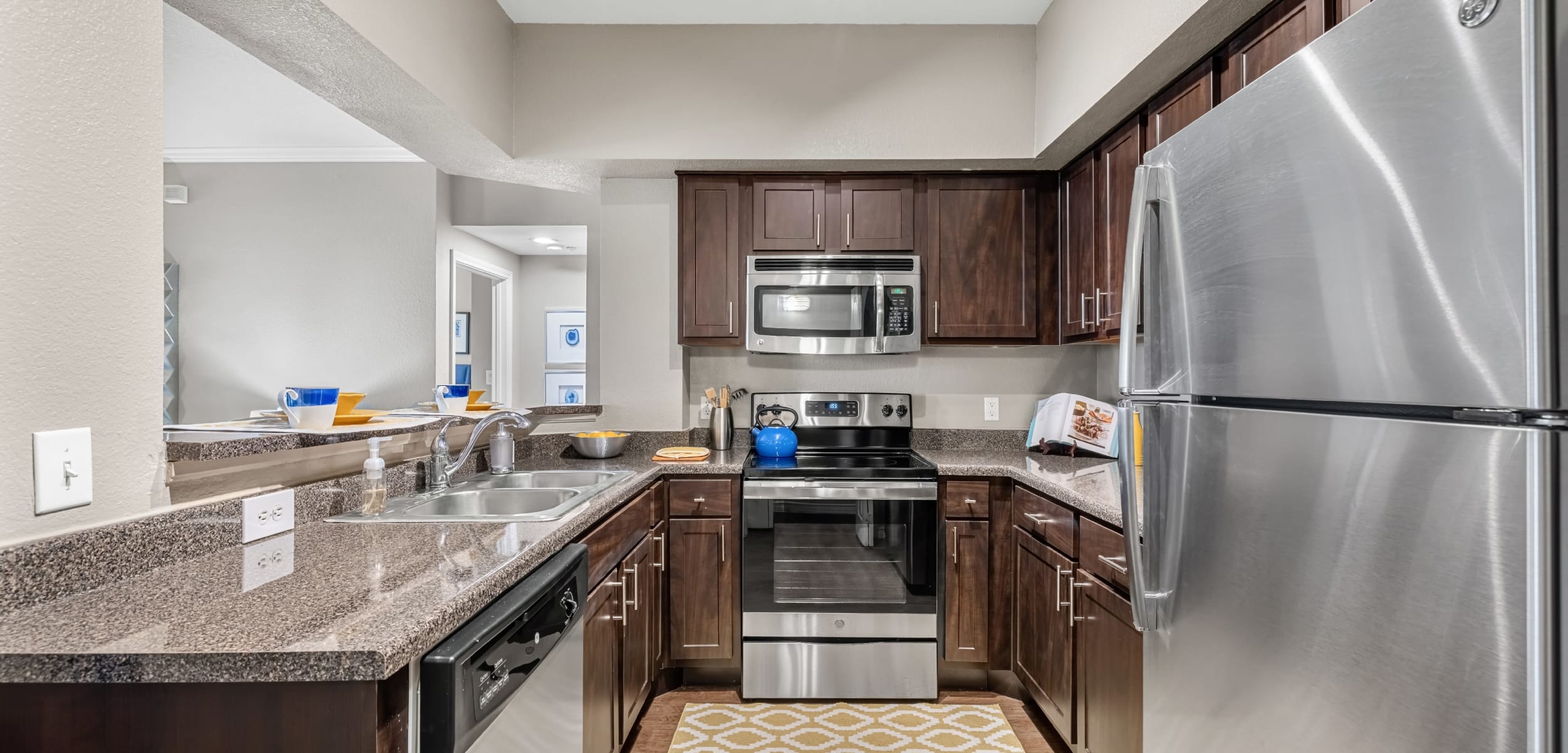 Kitchen with dark colored cabinets Marquis at Deerfield in San Antonio, Texas