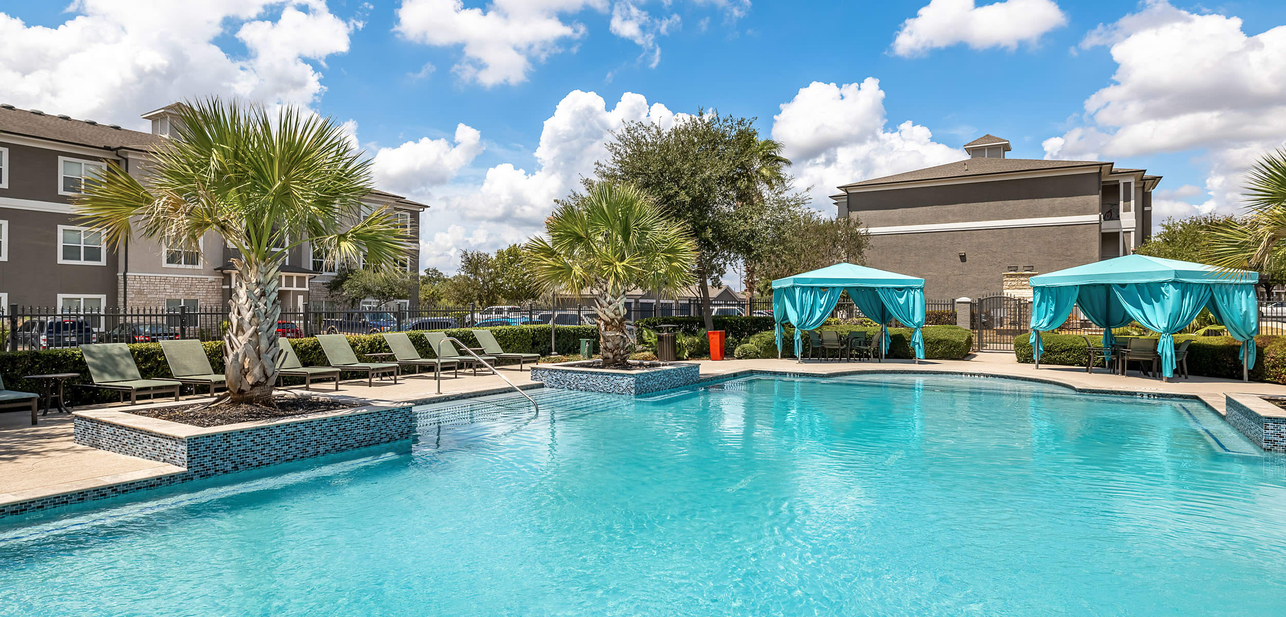 Sparkling pool with palm trees at Marquis at The RIM in San Antonio Texas,