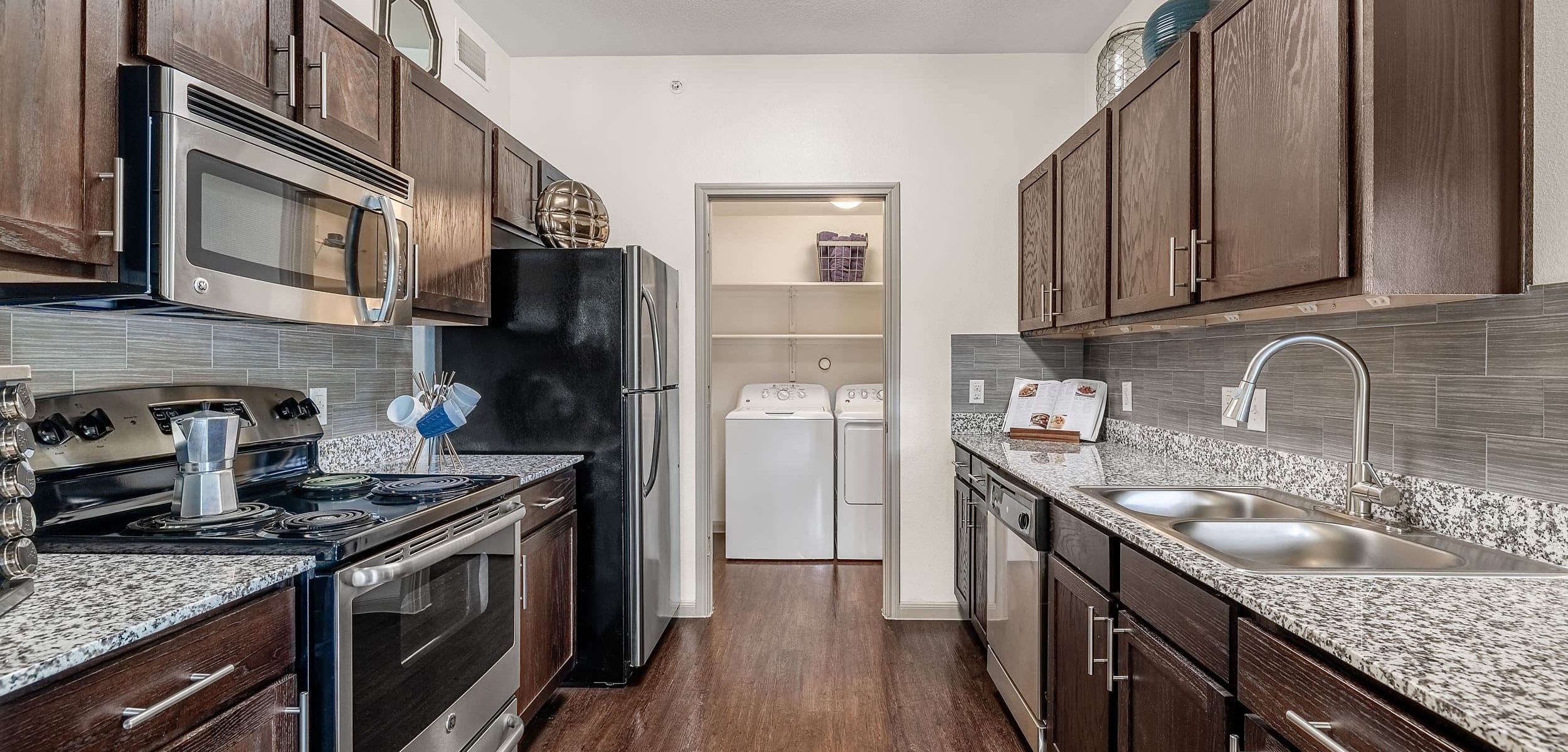 Modern kitchen with stainless steel appliances at Marquis on Lakeline in Cedar Park, Texas