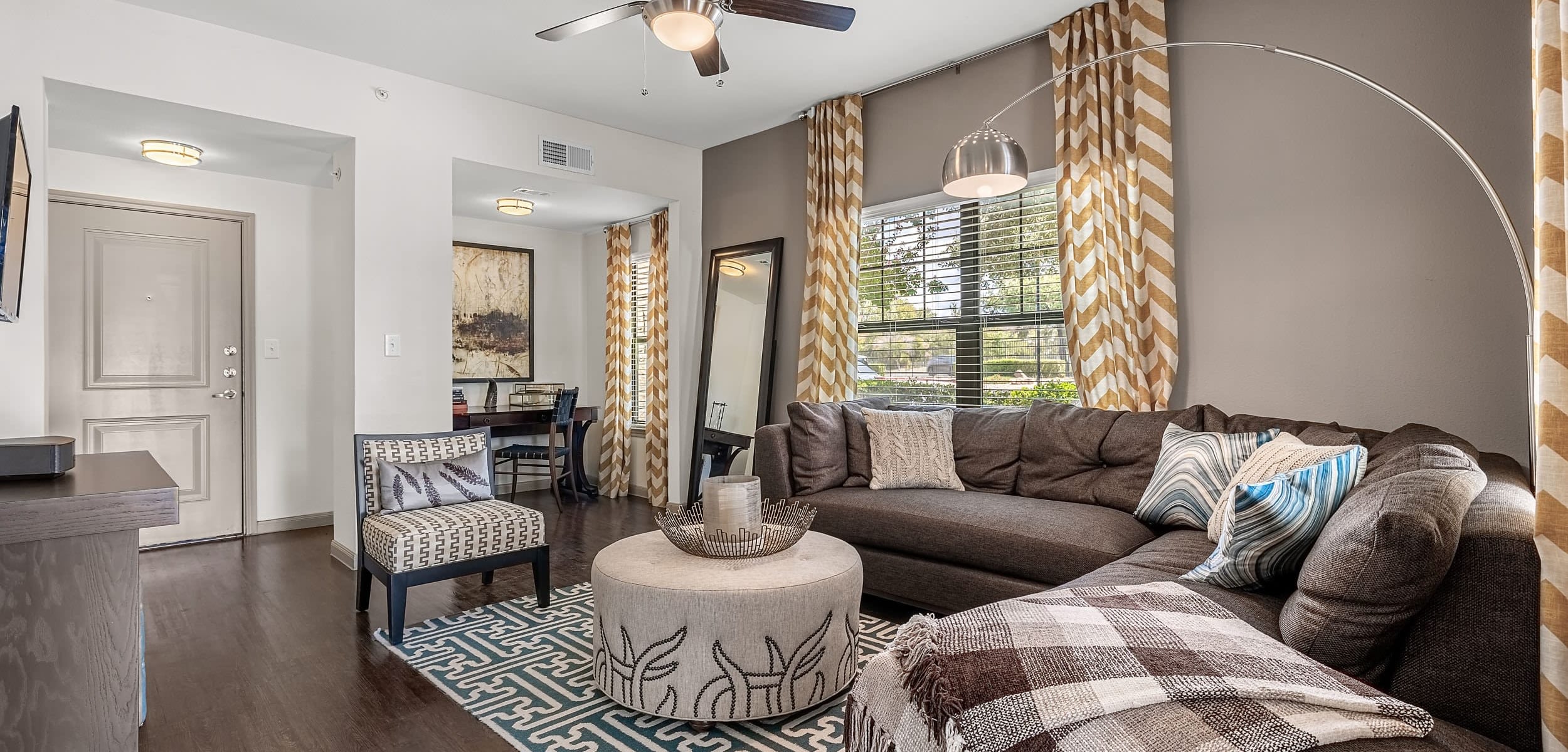 Open and bright living area with a large rug at Marquis on Lakeline in Cedar Park, Texas