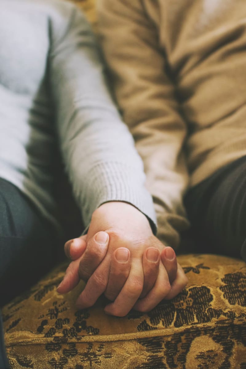 Residenst sitting holding hands at Fair Oaks Health Care Center in Crystal Lake, Illinois