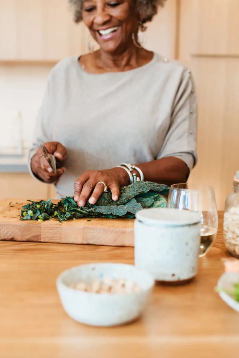 Resident chopping kale at Village on the Park Friendswood in Friendswood, Texas