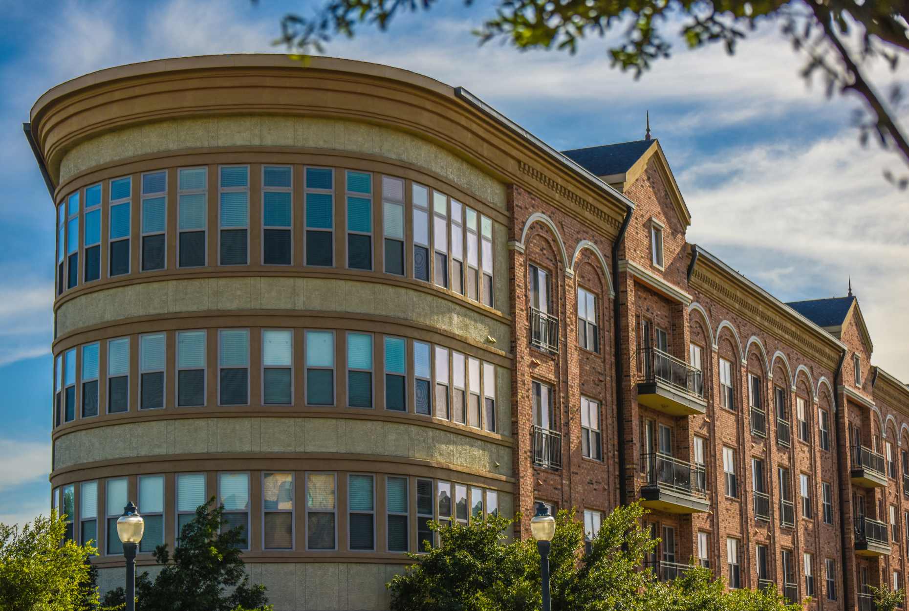 Brick building with glass windows at Flatiron District at Austin Ranch, The Colony, Texas