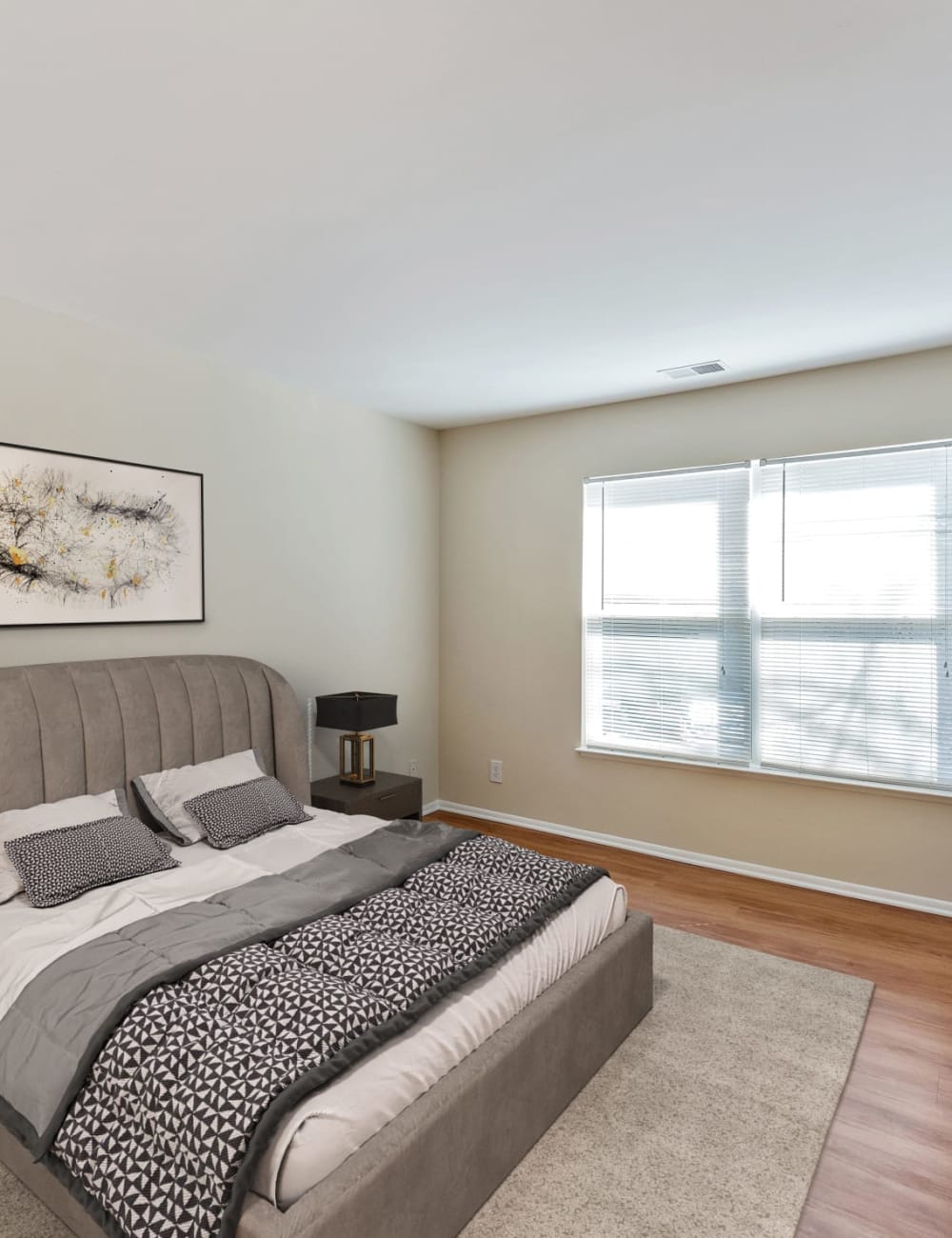Wood flooring in a furnished apartment bedroom at Stonecreek Club in Germantown, Maryland