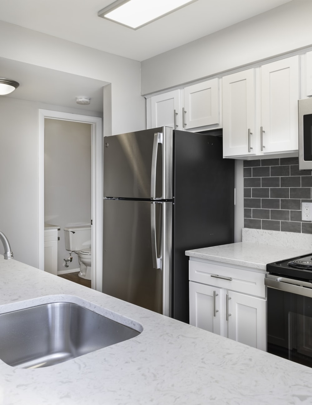 Stainless steel appliances in an apartment kitchen at Springwoods at Lake Ridge in Woodbridge, Virginia
