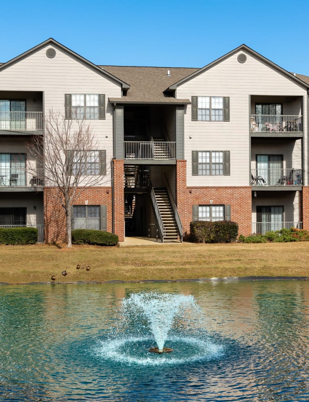 A water fountain next to apartment buildings at The Oaks of St. Clair in Moody, Alabama
