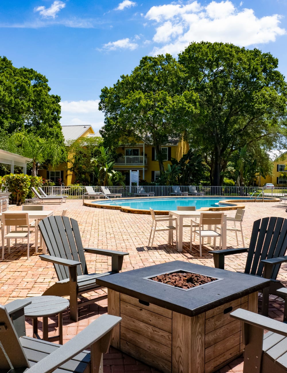 Outdoor fireside seating by the community swimming pool at Mode at Ballast Point in Tampa, Florida