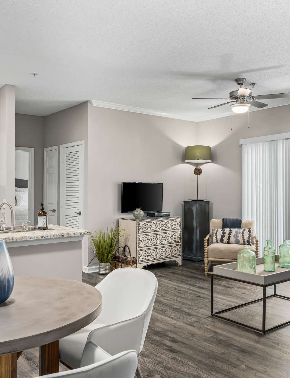 An apartment dining room and living room at The Oaks of St. Clair in Moody, Alabama